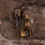 aerial photo of excavator road roller and bulldozer