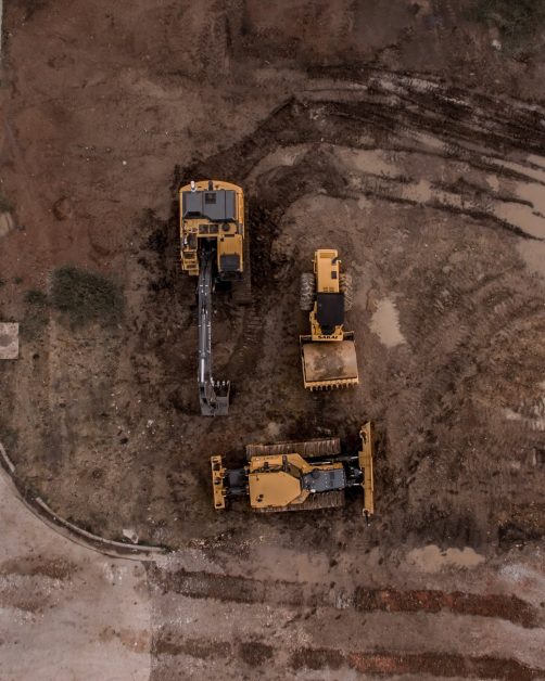 aerial photo of excavator road roller and bulldozer