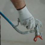 plumber holding silver faucet