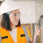 handywoman holding a plumbers wrench