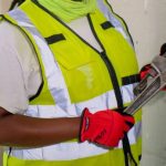 handywoman holding a plumbers wrench